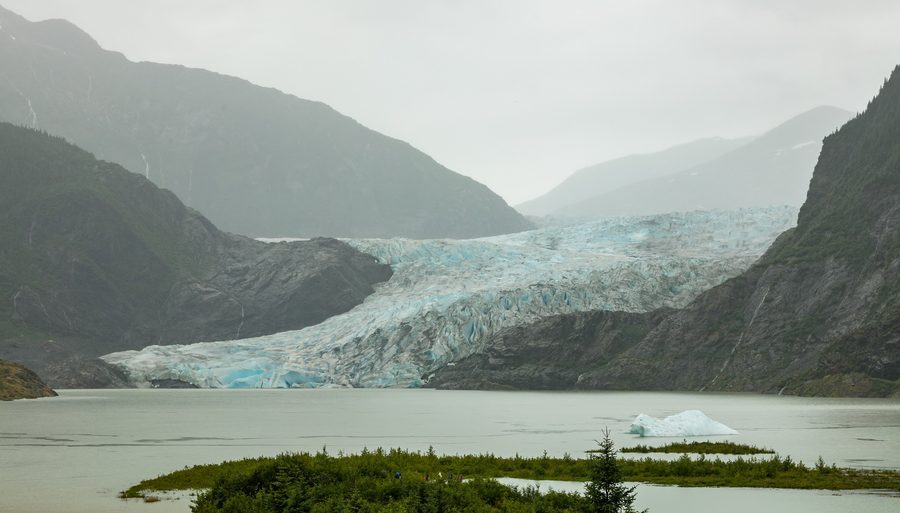 Mendenhall Glacier near Juneau with mountains and wooded surroundings