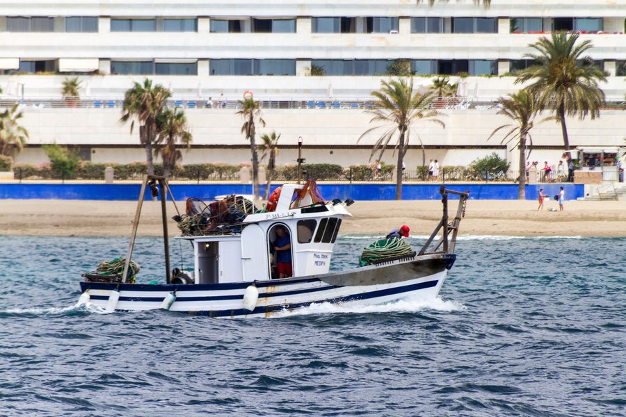 Small fishing boat on a beach in Marbella, Spain