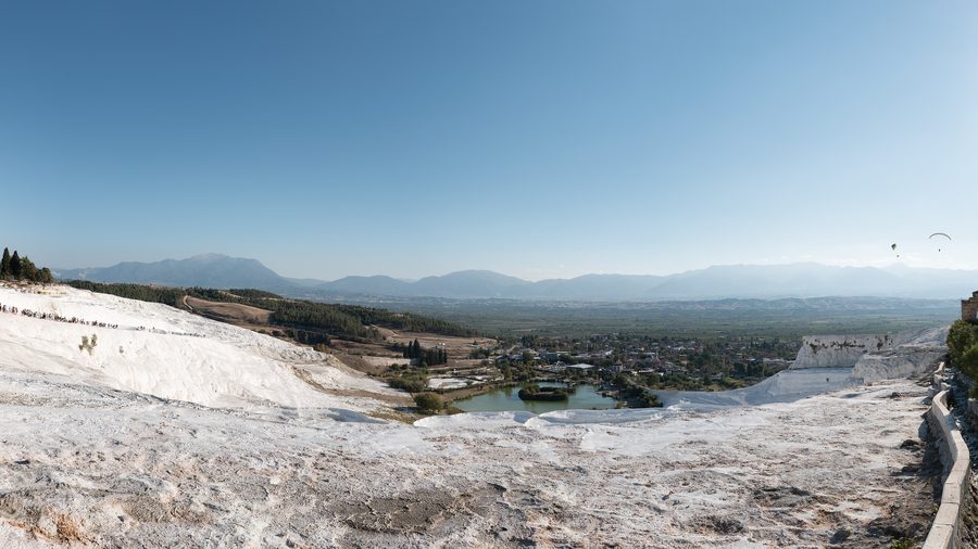 Wide view of Pamukkale's white travertine terraces with mineral pools
