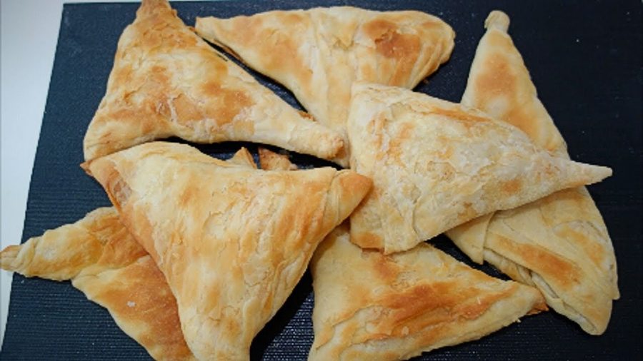 Triangle byrek on a plate.
