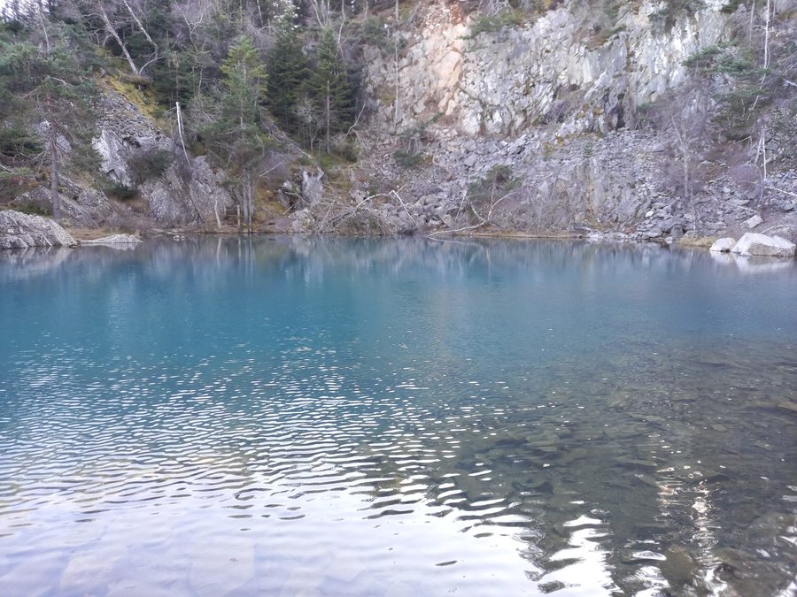 The blue lake of Champclause surrounded by rock faces