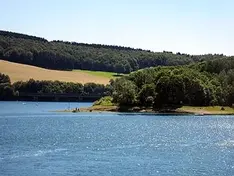 Biggesee with wooded shore and bridge